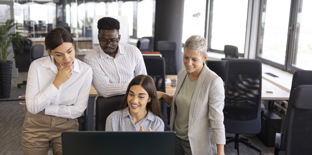 diverse group of people around a computer