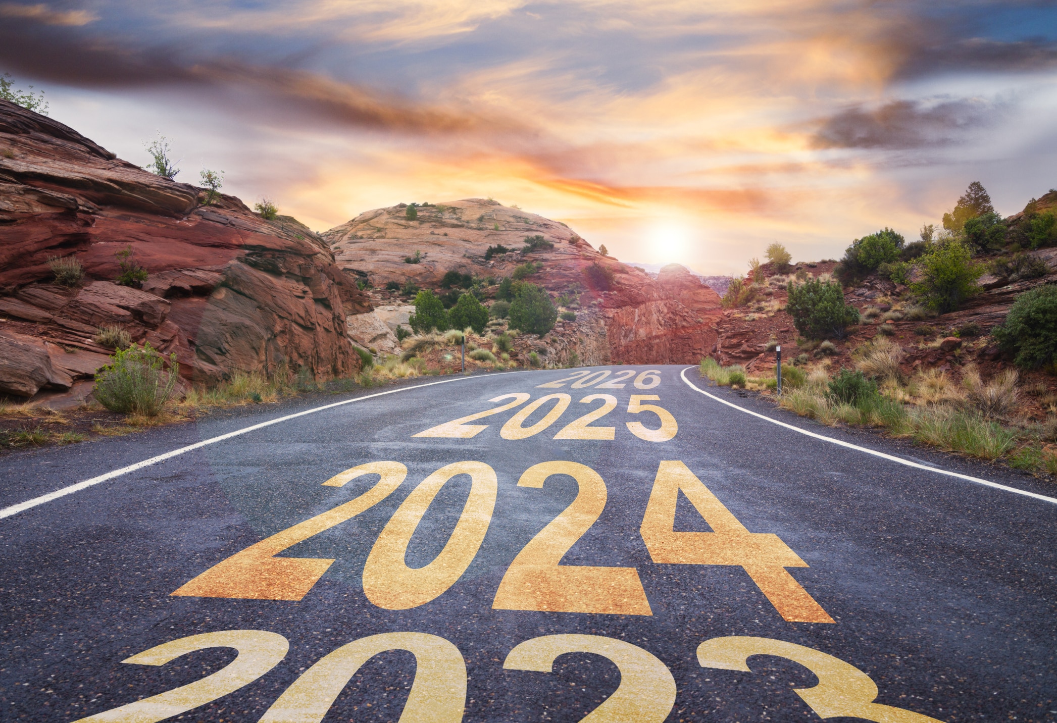 2023 changing to 2024 - road with sunrise and upcoming years ahead